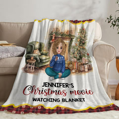 Living room staging of holiday throw blanket draped across a neutral sofa beside books.
