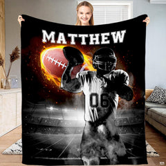 American football quarterback preparing to throw flaming football under stadium lights, view 1.