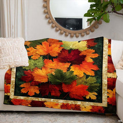 Folded rustic fall leaves throw blanket resting on wooden chair