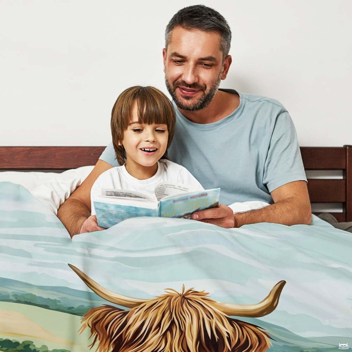 Close-up detail of folk art Highland cow face with curved horns on bedding set in a rustic farm bedroom setting.