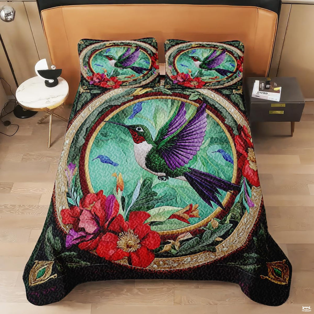 Overhead view of oval hummingbird bedding with red flowers and gold trim