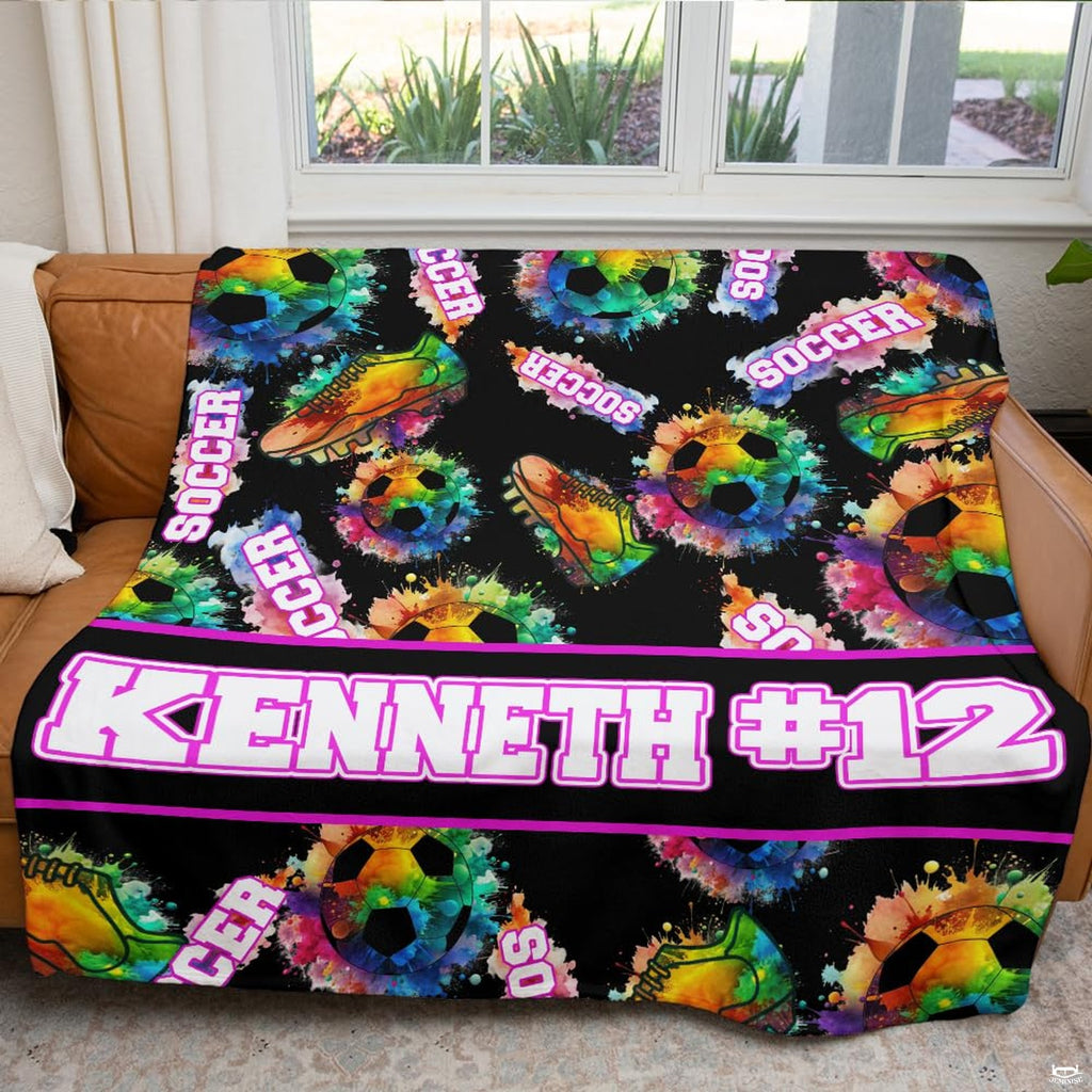 Colorful soccer artwork blanket folded on living room chair