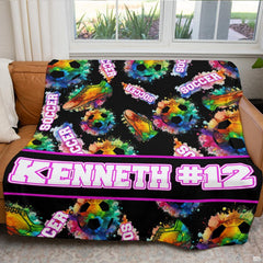 Colorful soccer artwork blanket folded on living room chair