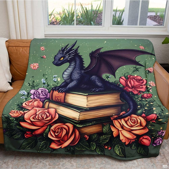 Fantasy dragon on books floral throw blanket held open displaying bookish fairytale artwork