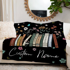 Wildflower books throw blanket draped across a leather couch in a sunlit living space.