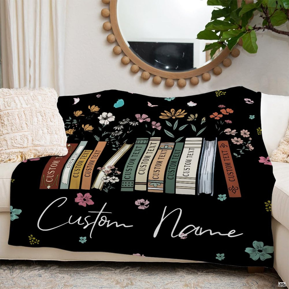 Wildflower books throw blanket draped across a leather couch in a sunlit living space.