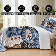 Festive bedding display with a snowman, pine trees, and rustic log cabin in a snowy mountain scene.