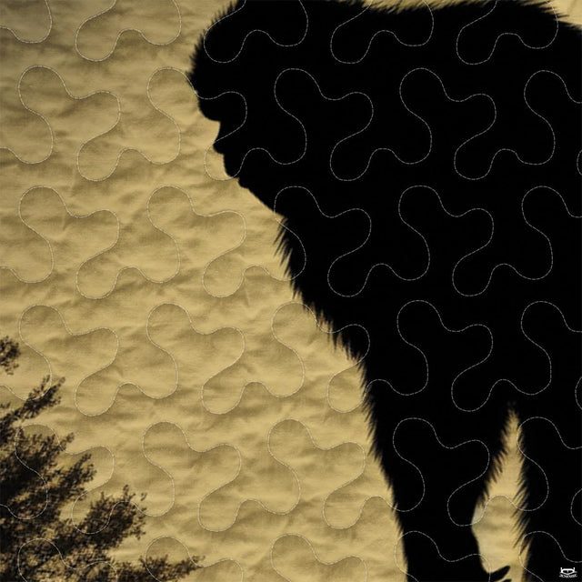 Close-up view of Bigfoot bedding showcasing vintage mustard gold tones, pine trees, and Sasquatch silhouette