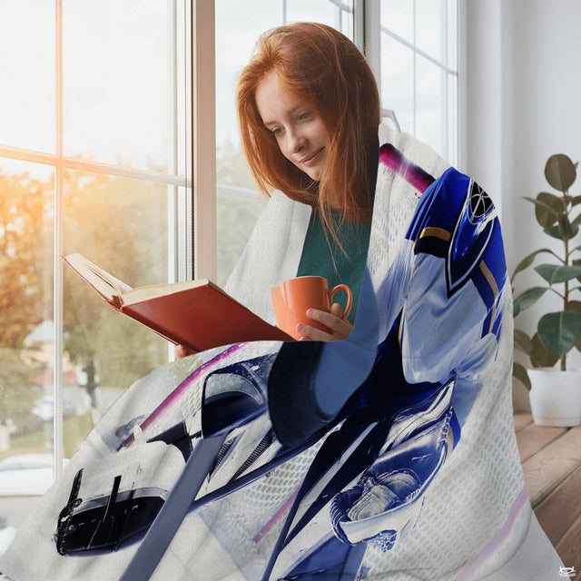 Hockey goalie save graphic blanket draped across living room couch
