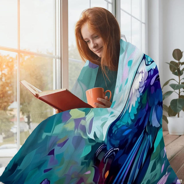 Turquoise hummingbird garden throw blanket view 2 highlighting blue plumage artwork and home decor styling