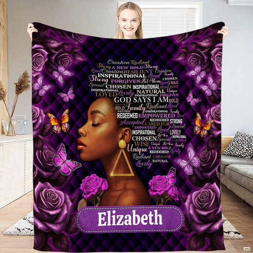 Woman holding up a purple blanket featuring a black woman profile with roses and butterflies.