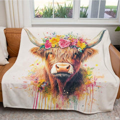 Folded floral crown Highland cow throw blanket resting on wooden bench displaying pastel colors