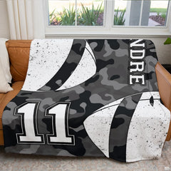 Overhead view of dark grey camouflage football print bedding set.