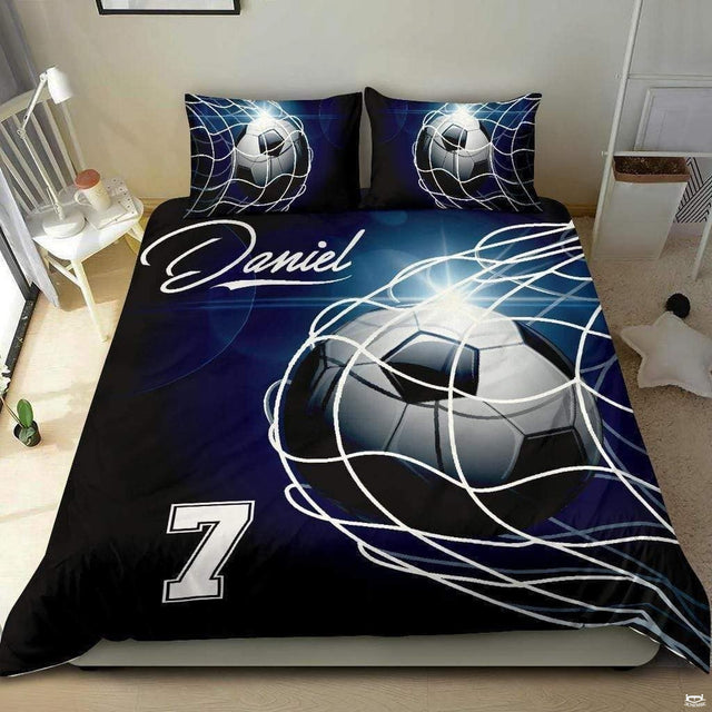 Indigo navy and silver soccer cleats sports bedding featuring athletic soccer footwear and a ball on a bed