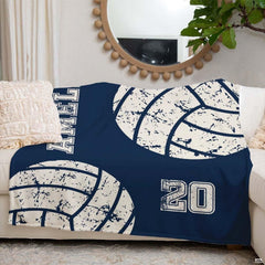 Overall bedroom display featuring navy sports bedding accented by vintage volleyball prints.