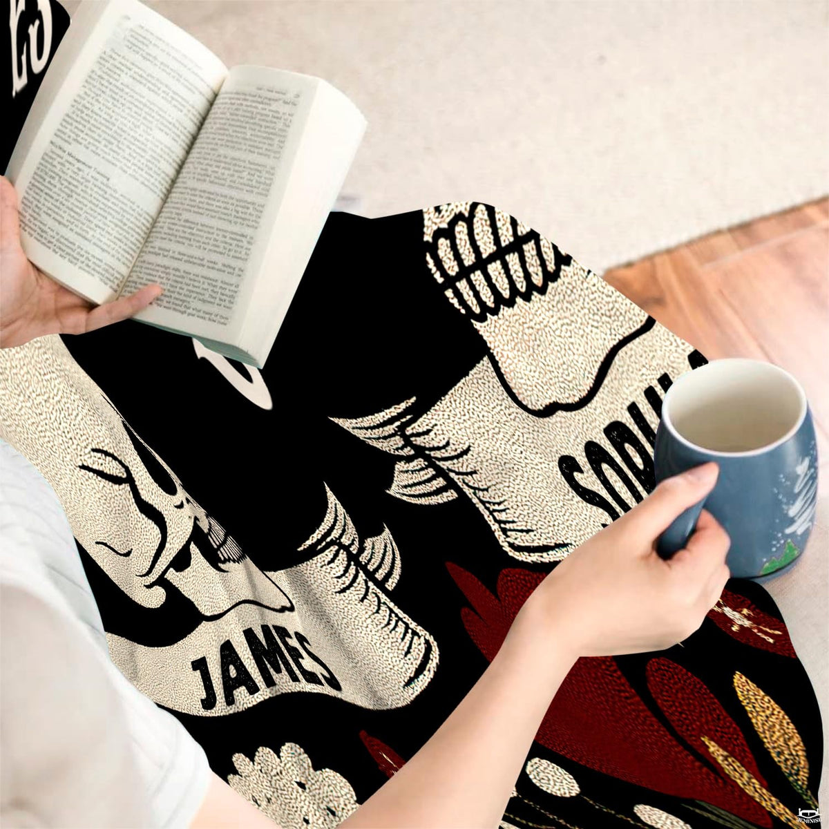 Overhead view showing gothic skull throw blanket folded with decorative pillows.