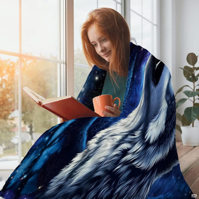 Living room sofa display showing the midnight blue howling wolves throw blanket draped over furniture.