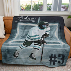 Youth ice hockey player sports blanket styled across bedroom bed