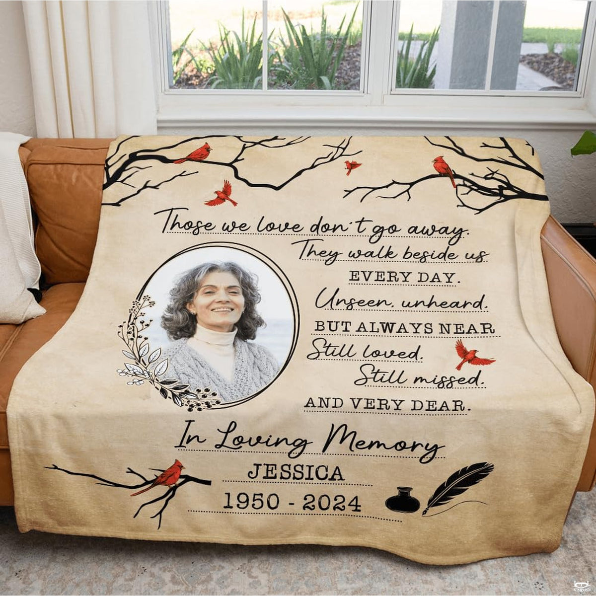 Cardinal memorial throw blanket spread neatly over a bed