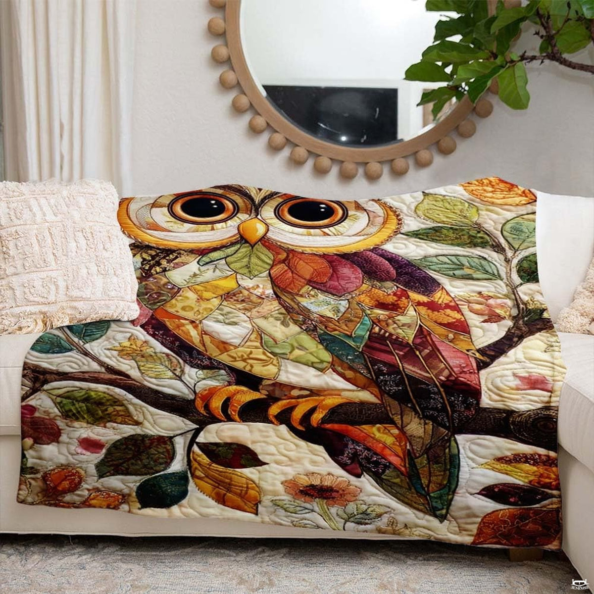 Side view showing saffron, russet, and sage green palette of the owl blanket