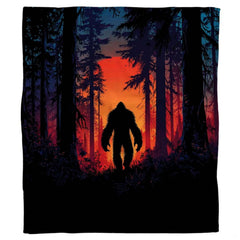 Sunset Bigfoot throw blanket view 2 highlighting fiery amber sunset and pine timber silhouettes