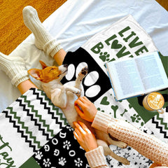 Artistic dog paw bedding pattern featuring alternating black, white, and olive green decorative square blocks.