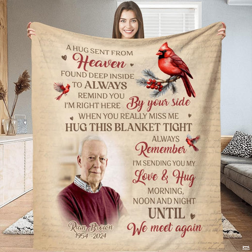 Front view of hug sent from heaven throw blanket held upright showcasing memorial cardinal artwork.