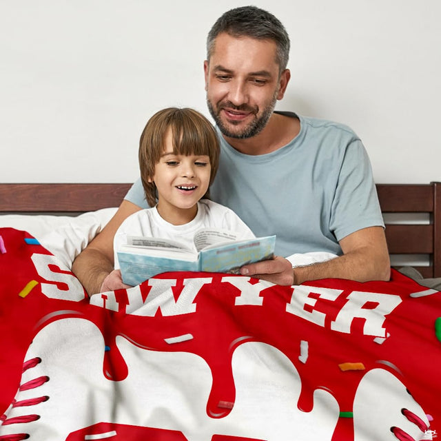 Bedroom setting featuring baseball sports themed bed drape with red seam accents and colorful flecks.