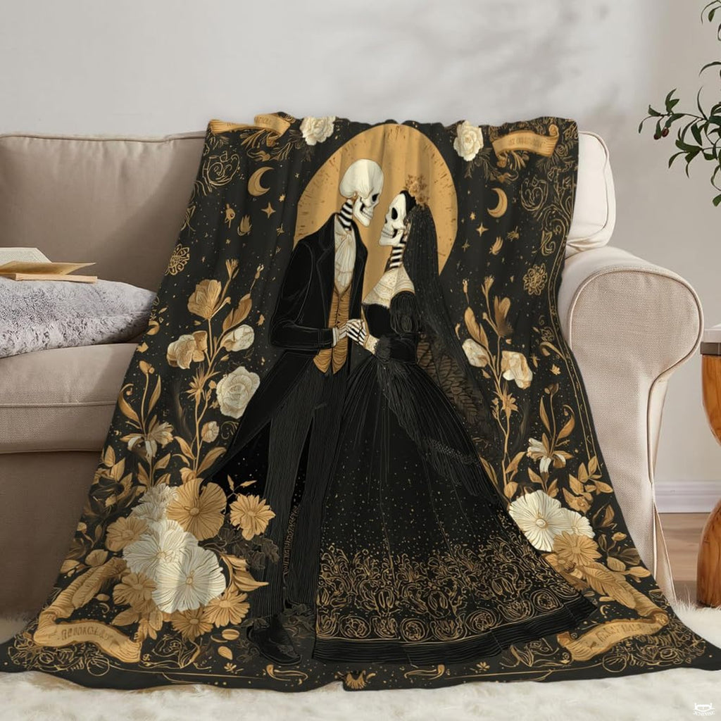 Detail view of gilded rose illustrations and ornate baroque scrollwork on throw blanket