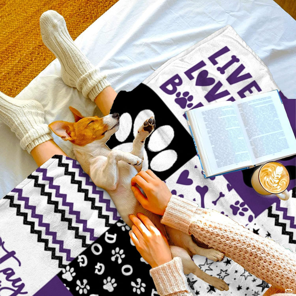 Styled bedroom scene displaying the purple and black pet-themed geometric patchwork motif bedding set.