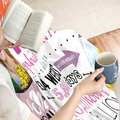 Close-up perspective of photo collage blocks and birthday quotes on throw blanket