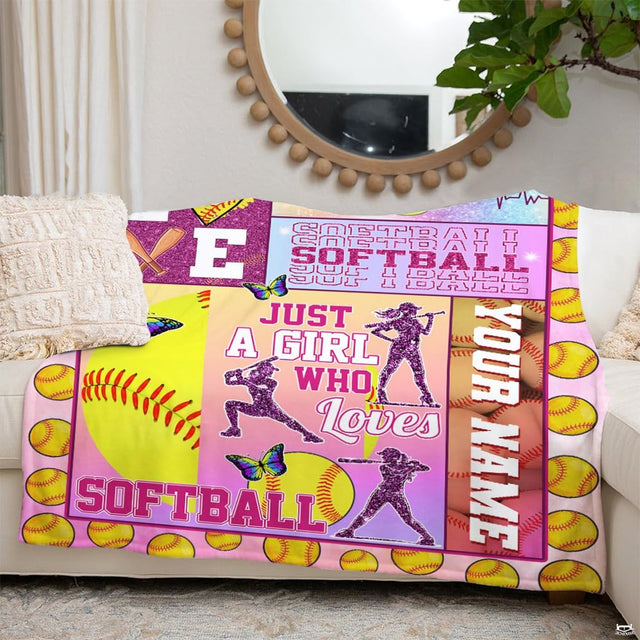 Living room staging of softball collage throw blanket draped over a white couch beside a wall mirror.