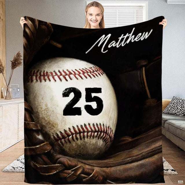 Realistic baseball with crimson lacing resting inside a fielder mitt against dark shadows, view 2.