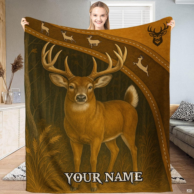 Model holding up a wildlife blanket displaying a standing whitetail buck in a woodland forest clearing.