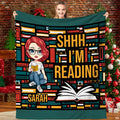 Front view of reader girl throw blanket showing geometric book spine mosaic and open volume graphic.