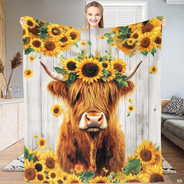 Highland cow bedding sets displaying floral wreath artwork against whitewashed wood background