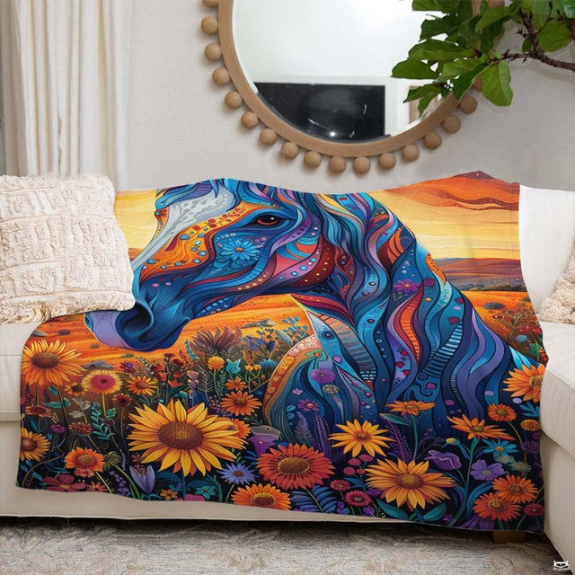 Woman holding open psychedelic blue horse sunflower throw blanket in bright sunny room