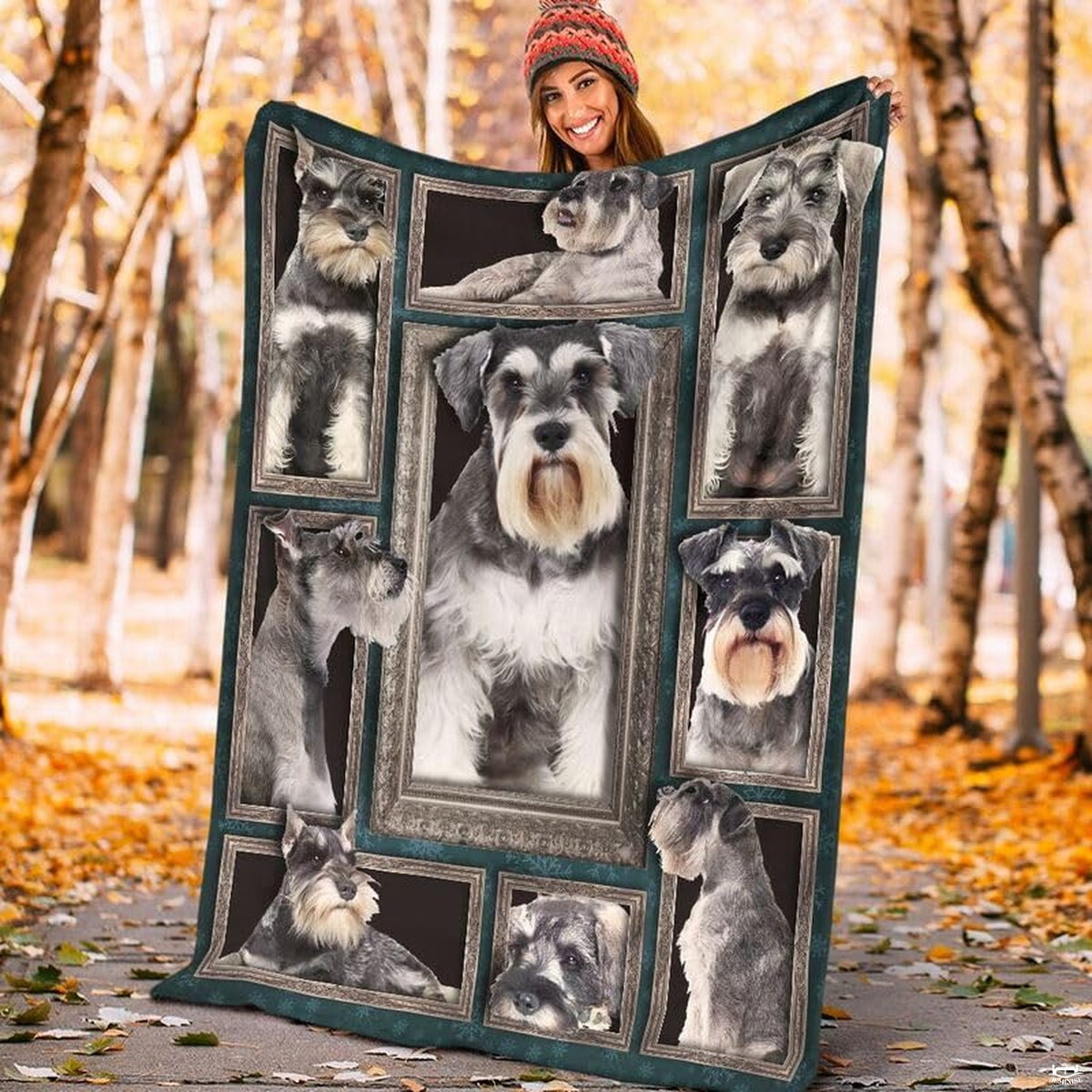 Model displaying the rectangular Miniature Schnauzer portrait blanket outdoors in an autumn park.