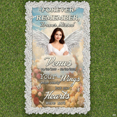 Folded display of memorial tribute grave blanket showing corner grommets and print texture.