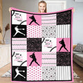Woman displaying pink and black fastpitch batter patchwork blanket indoors