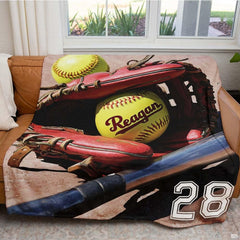 Close view of crimson fielder mitt and yellow softball on blanket
