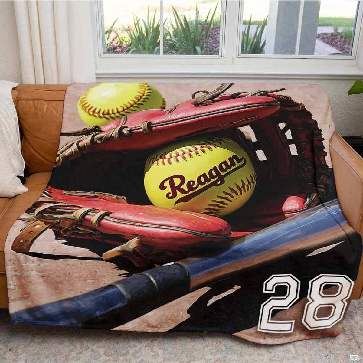 Close view of crimson fielder mitt and yellow softball on blanket