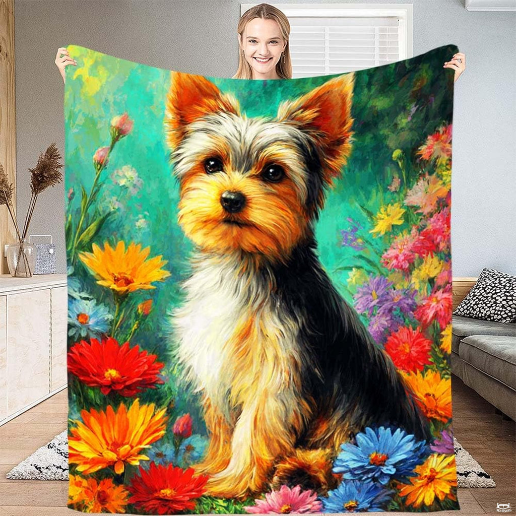 Yorkshire terrier puppy resting amid bright wildflowers on teal bedding