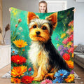 Yorkshire terrier puppy resting amid bright wildflowers on teal bedding
