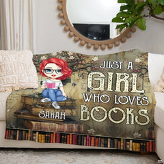 Folded view of manuscript reader girl throw blanket showing book spine borders and floral boughs.