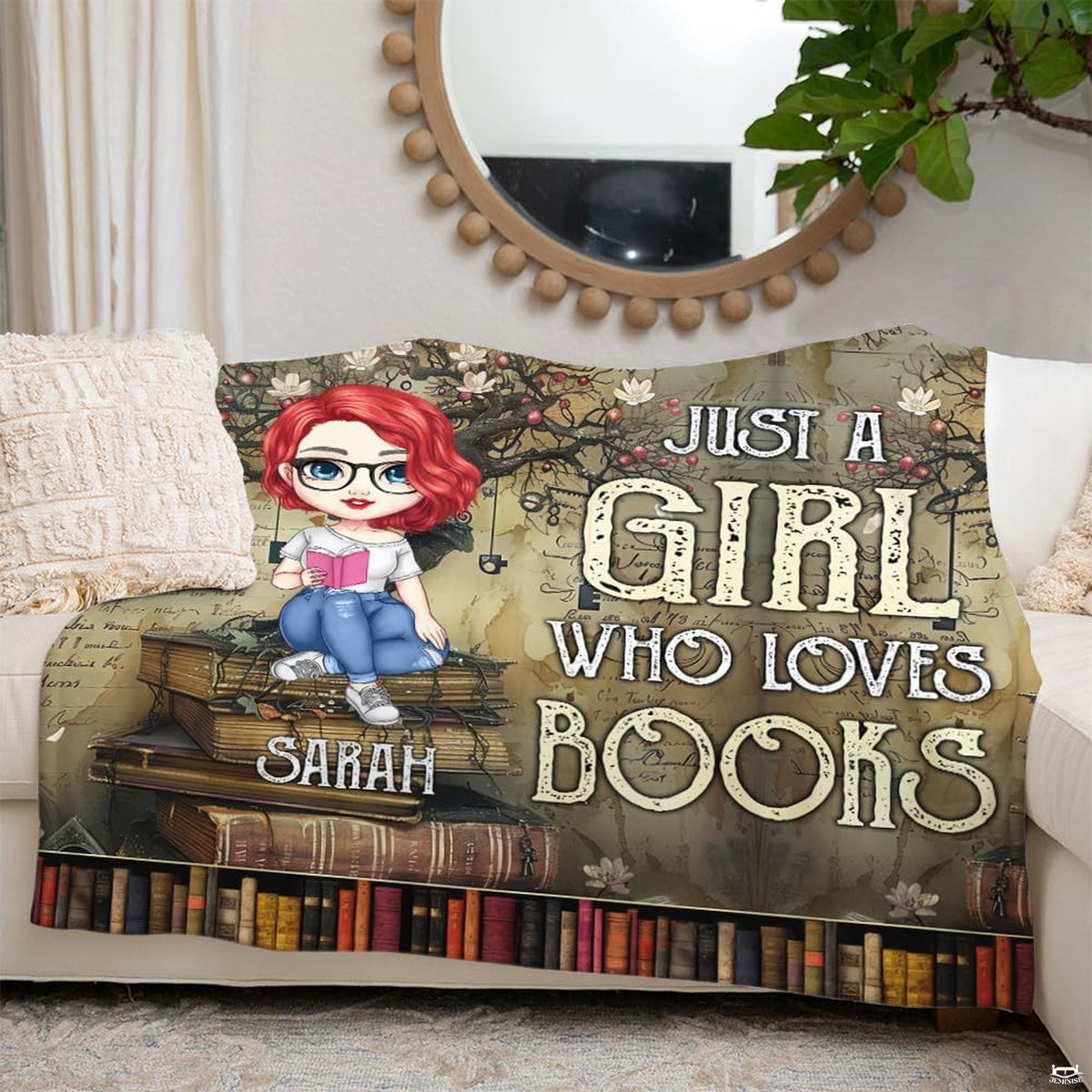 Folded view of manuscript reader girl throw blanket showing book spine borders and floral boughs.