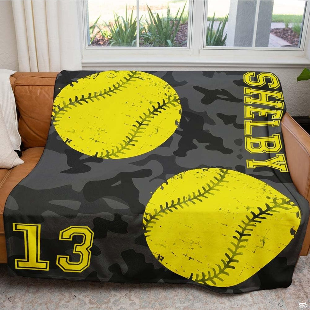 Close view of distressed yellow softballs and camo print on blanket