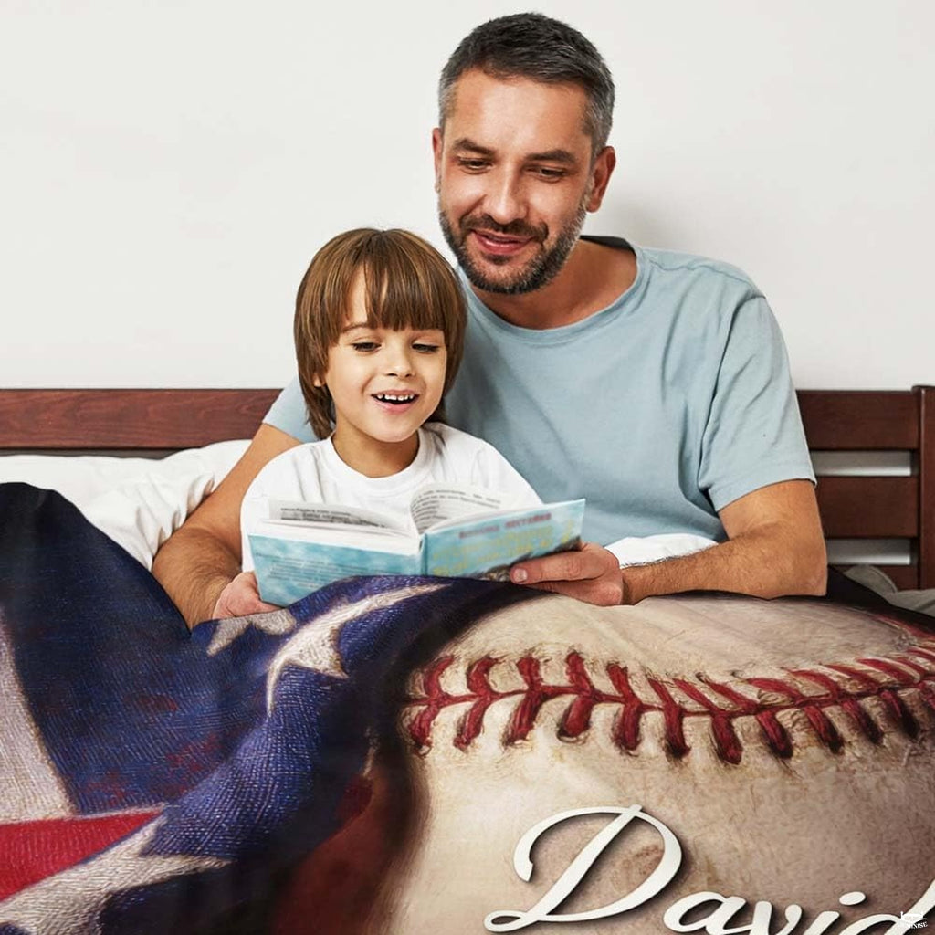 Detailed artwork of textured baseball beside stars and stripes on themed bedding.