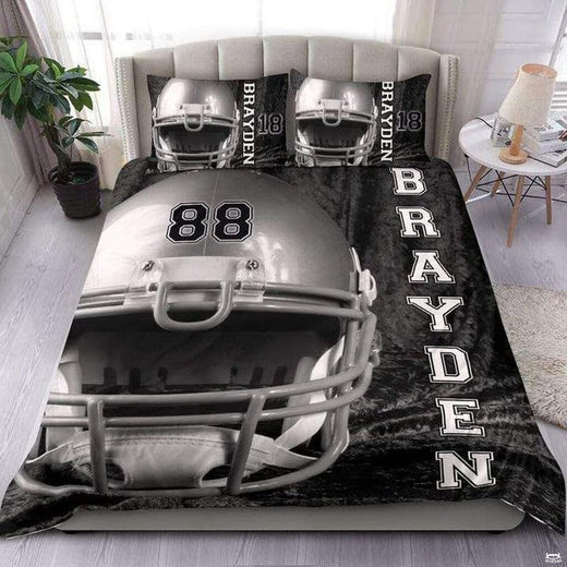 American football pattern sports bedding featuring football graphic and yard lines on slate backdrop on a bed