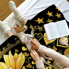 Overhead perspective of person and resting pet on bed with the golden sunflower graphic.